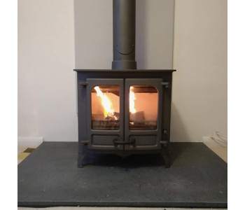 Charnwood Stoves Island - 2 stove in gun metal with green slate hearth and oyster Vlaze heat shield along with internal chimney system.